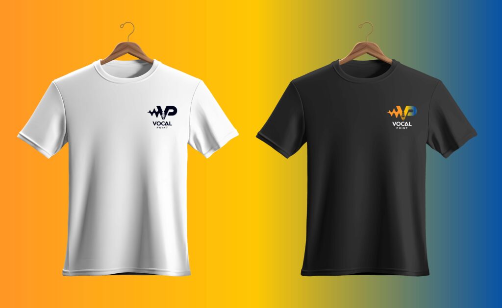 Two T-Shirts On Wooden Hangers Displayed Against A Yellow-To-Blue Gradient Background. The White Shirt Has The Vocal Point Logo In Black On The Chest, And The Black Shirt Has The Same Logo In Multicolor Orange, Yellow, And Blue.